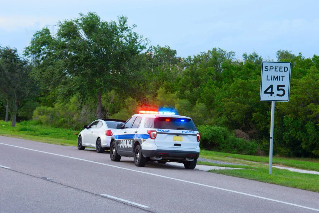 A driver holding a speeding ticket with legal guidance provided by Constantinou and Burkert Accident Injury Lawyers in Durham North Carolina